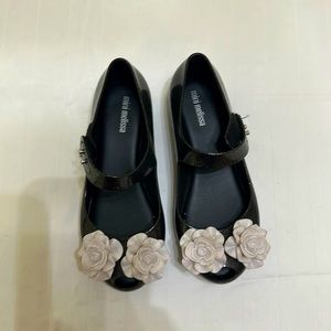 Black glittery mini Melissa’s jelly shoes with white flowers
